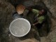 Women with a child collecting water - Pierre Holtz for UNICEF